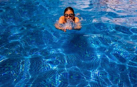 Cute boy in a swimming pool Stock Photos