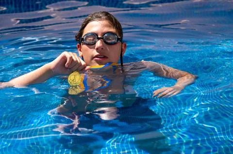 Cute boy in a swimming pool Stock Photos
