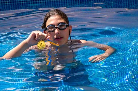 Cute boy in a swimming pool Stock Photos