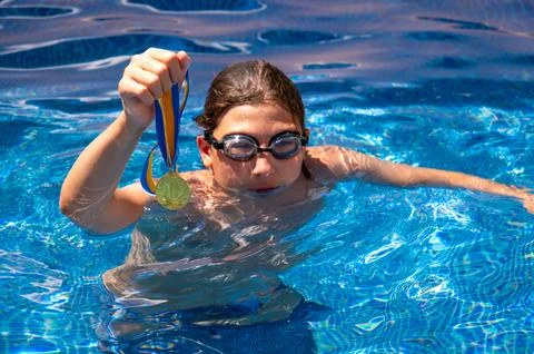 Cute boy in a swimming pool Stock Photos