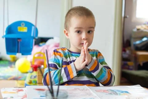 Cute boy thinking what to paint and draw. Children's creativity. Stock Photos