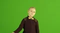 The cute boy thumb down on the green background 4k or 4k+ Resolution