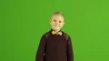 The cute boy thumb up on the green background 4k or 4k+ Resolution