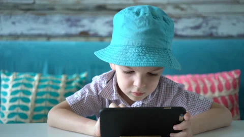 Cute boy using smartphone sitting in cafe. Stock Footage 106310301