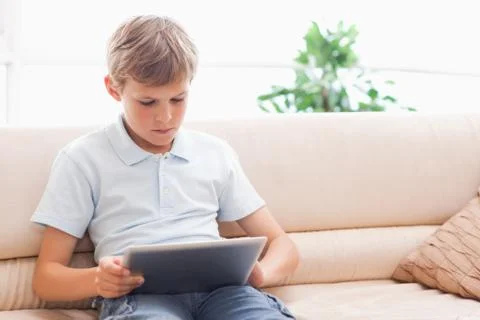 Cute boy using tablet computer Stockfoto's