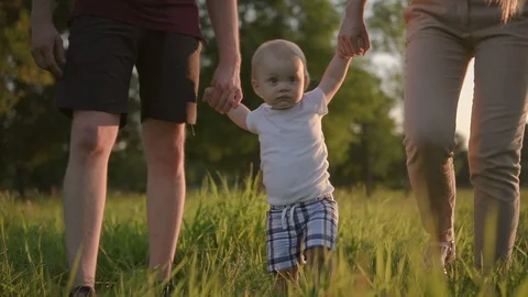 Cute boy walking with his first mother and father in the park. Stock Footage 94774765