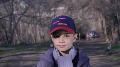 Cute boy walking on railway in forest with a book in his hand Stock Footage 172584813