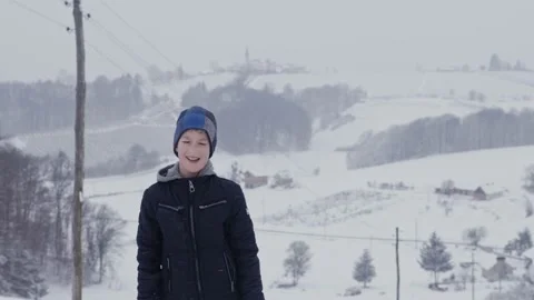 Cute boy in warm clothing pulling wooden sled on snowy winter day Stock Footage 147855939