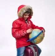 a girl in a white down jacket walks in a hood in the snow. winter