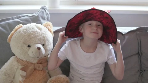Cute boy in a wizard hat plays on a sofa at home Stock Footage 118517668
