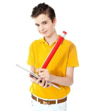 Cute boy writing on his notebook Stock Photos