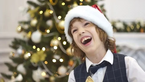 Cute boy of younger school age laughs near the Christmas tree. Stock Footage 70783270
