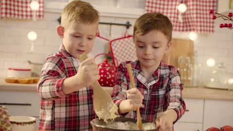 Cute boys making gingerbread dough together at the kitchen on Christmas eve Stock Footage 265847934
