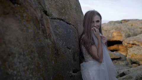 Cute bride poses in the mountains Stock Footage 129072998