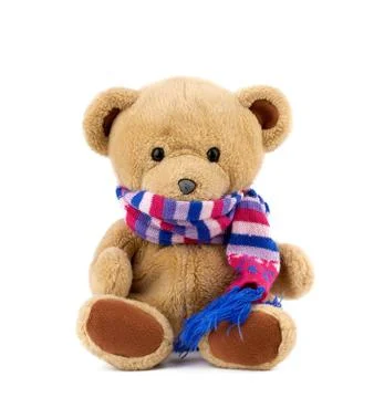Cute brown teddy bear in a colored knitted scarf sitting on a white backgroun Stock Photos