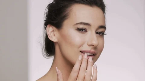 Cute brunette girl posing at gray backgr... | Stock Video | Pond5