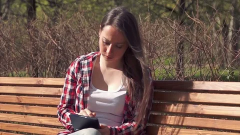 Cute brunette girl using digital tablet Видео 75642953