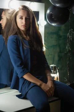 Cute brunette posing while sitting Stock Photos