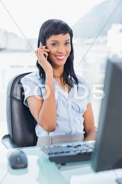 Cute businesswoman calling someone with her mobile phone Stock Photos