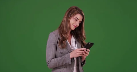 Cute Businesswoman intern using smartphone to communicate on green screen Stock Footage