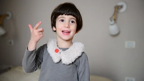 Cute caucasian child learns to count and smiles 스톡 동영상 124947774