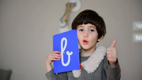 Cute caucasian child learns to write and count with Montessori letters 스톡 동영상 124946828