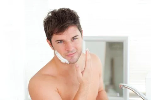 Cute caucasian man ready to shave in the bathroom Stock Photos