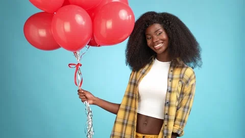 Cute charming lady hold red air balloons isolated blue color background Stock Footage 166158089