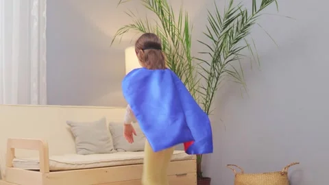 Cute charming little brown haired girl wearing superhero costume and mask Vidéo 263619198