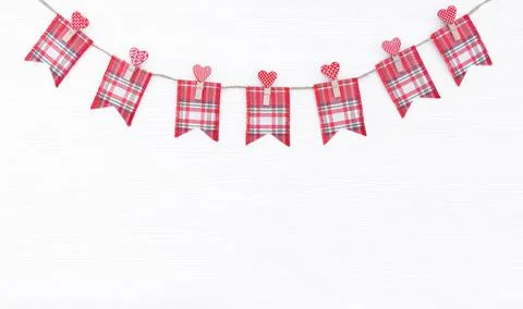 Cute checkered fabric flags attached to jute rope with clothespins Stock Photos