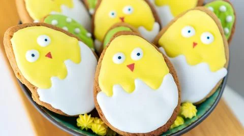Cute chickens Easter background. Iced sugar cookies in bright frosting. Stock Photos