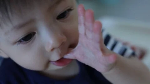 Cute child baby using finger hand in mouth itchy gum, slow motion scene Stock Footage 80923694