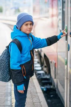 Cute Child with Backpack Pressing Train Door Button at Railway Station Platfo Stock Photos