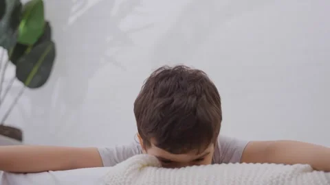 Cute child boy having fun in the bedroom in the morning Stock Footage 257012172