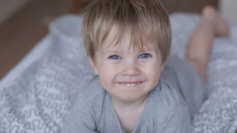 Cute child boy laughing, clapping hands and having fun at home. Stock Footage 93863998