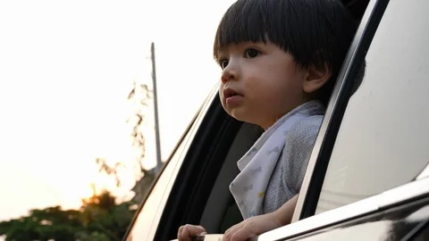 Cute child boy looking through window in car enjoy road trip travel Stock Footage 93106909