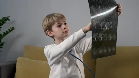 Cute child boy playing with stethoscope acting a doctor Video stock 183069949