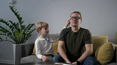 Cute child boy playing with stethoscope acting a doctor. Stock Footage 187066614