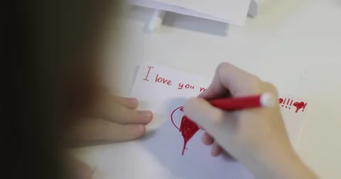 Cute child draws a red heart on a white sheet of paper. Stock Footage 110698561