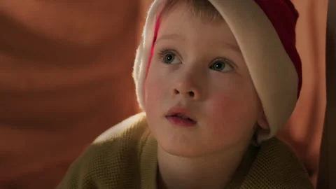 Cute child dreaming on Christmas Eve in a cozy home atmosphere Stock Footage 320140341
