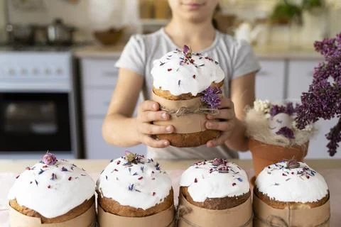 Cute child girl holds an Easter cake in his hands. Happy Easter. Homemade cakes Stock Photos
