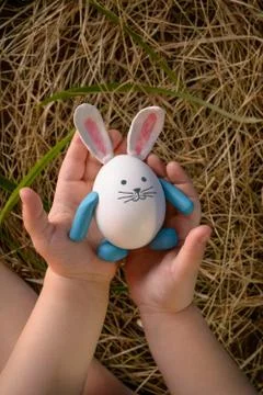 Cute child keeps funny rabbit - easter egg. Stock Photos