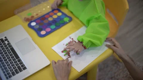 Cute child learning to draw a tree using water color Stock Footage 158951219