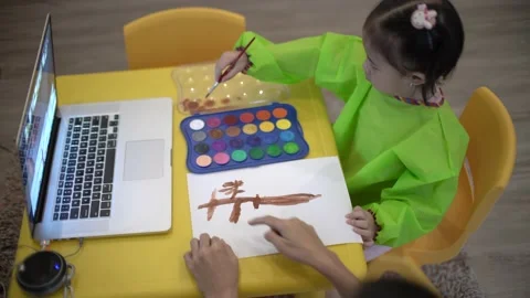 Cute child learning to draw a tree using water color Stock Footage 158951287