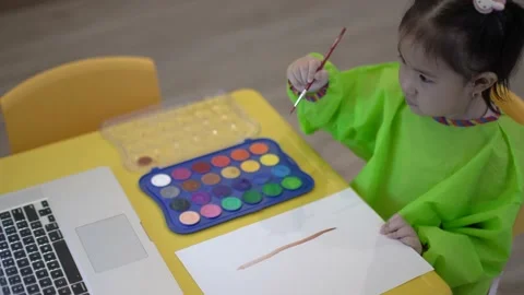 Cute child learning to draw a tree using water color Stock Footage 158951308
