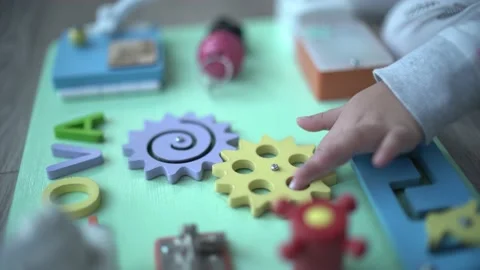 Cute child learning to operate basic machine with montessori method Stock Footage 158951130