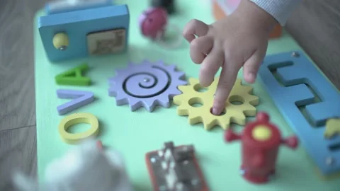 Cute child learning to rotate object with montessori method Stock Footage 158951127