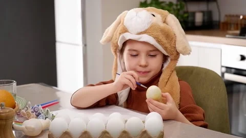 Cute child painting easter eggs at home Stock Footage 303341839