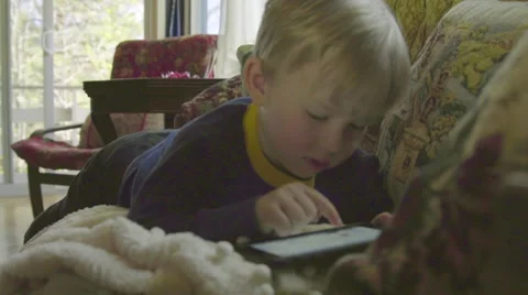 Cute child playfully uses technology Stock Footage 64644330