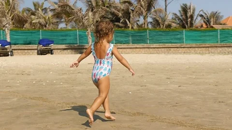 Cute child playing on the beach in summer vacation.  Slow motion. Stock Footage 50591006